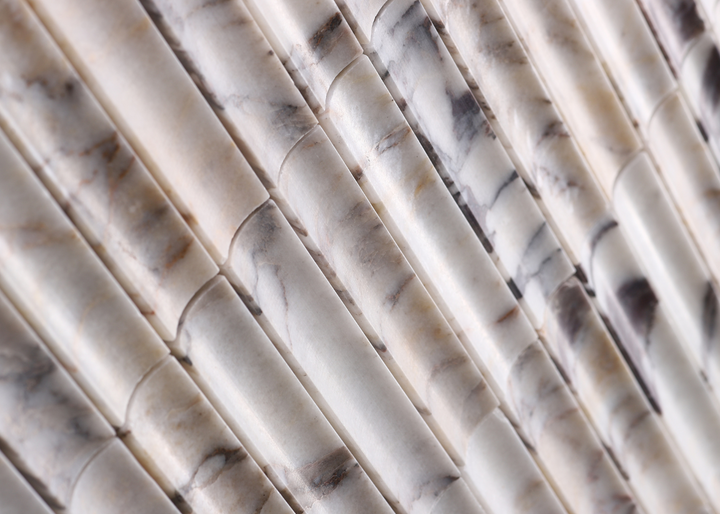 Close-up of inverted flute marble tile surface in Calacatta Viola