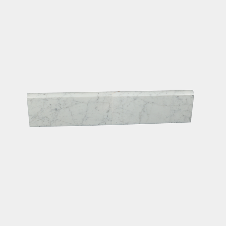 Close-up of White Carrara marble surface on modern skirting board